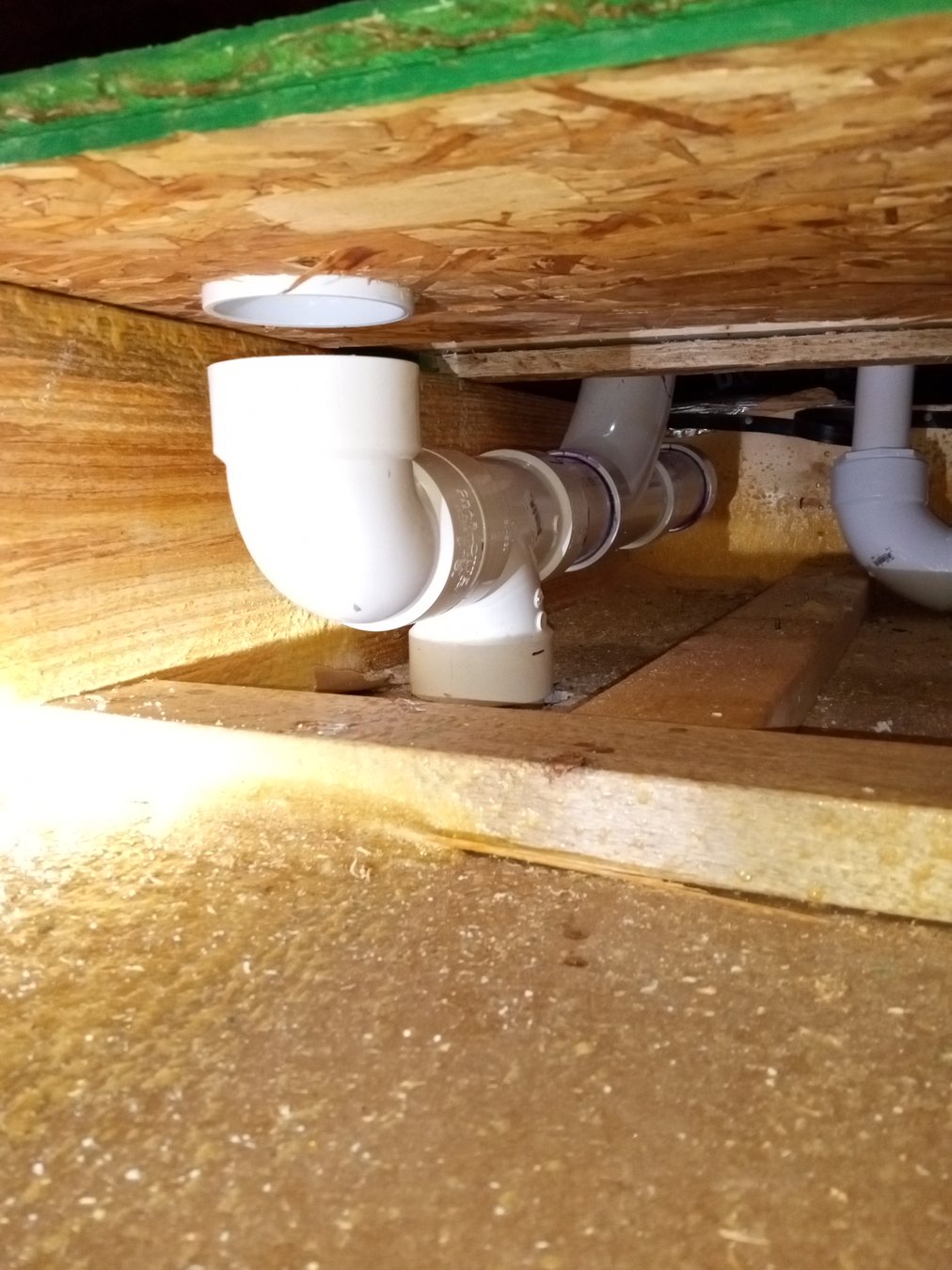 Minor plumbing connection beneath a floor